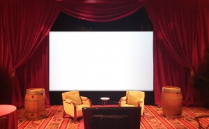 Movie Screen flanked by Red Velour / Red Velvet Drapery From Turn of Events Las Vegas Rental Drapery