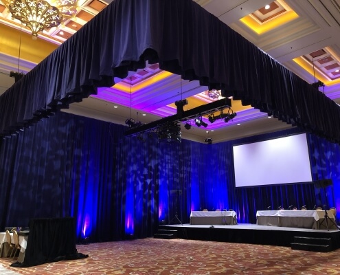 Purple Velour / Purple Velvet Rental Drapery Installed By Turn of Events Productions Hung on a Truss. Also Purple Velour / Velvet Drapery from Floor to Ceiling From Turn of Events Las Vegas Rental Drapery