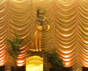 Custom Gold Austrian Drapery Entrance with plants and cat statue from Turn of Events Las Vegas