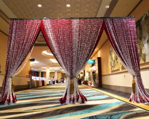 Red Velour Drapery Entrance adorned with Iridescent Tear Drop Beading Divider from Turn of Events Las Vegas