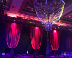 Red Bellowed Velour Velvet Drapery with a Hanging Beaded Chandelier from Turn of Events Las Vegas